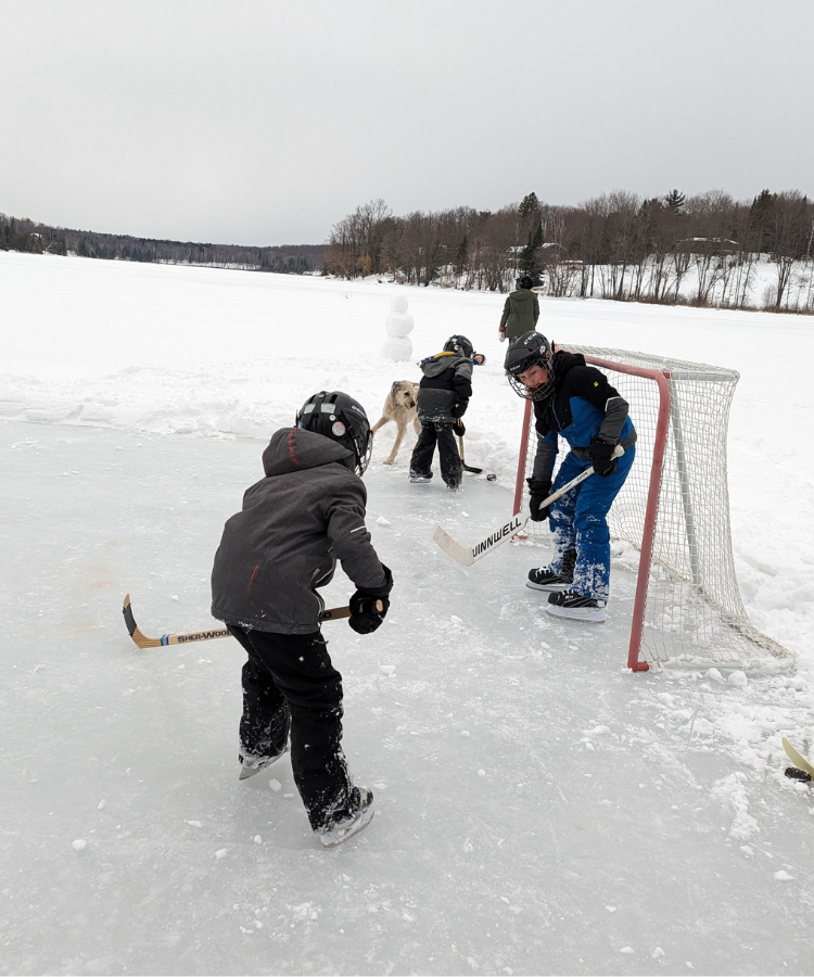 Kids playing hockey on lake